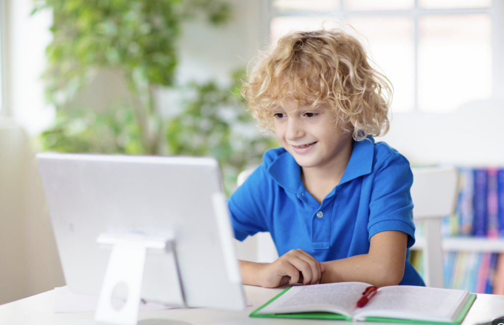 Child having fun and learning at online summer school